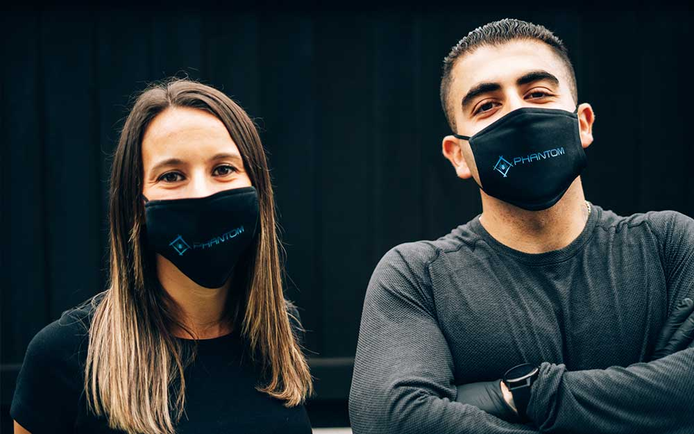 Two Phantom Pest Control team members wearing Phantom-branded face masks